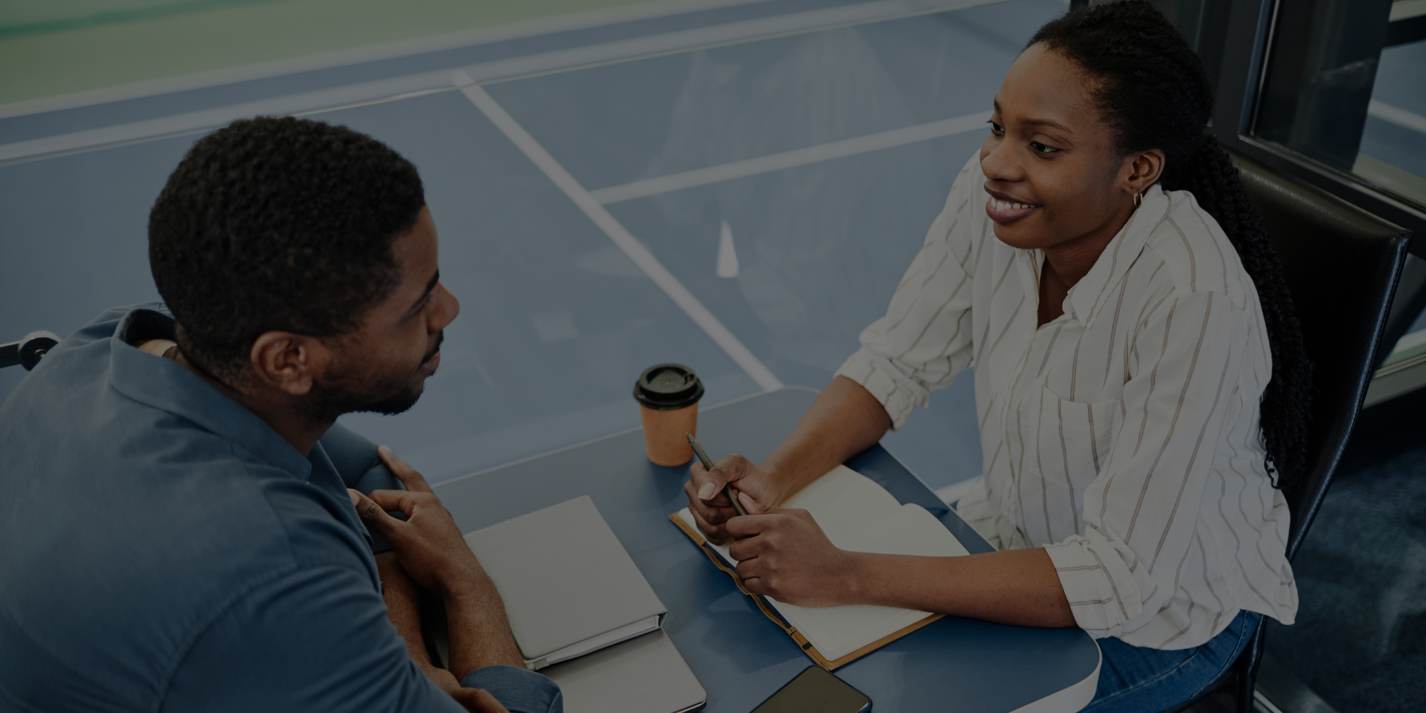 Two sports industry professionals completing a practice interview and resume review.